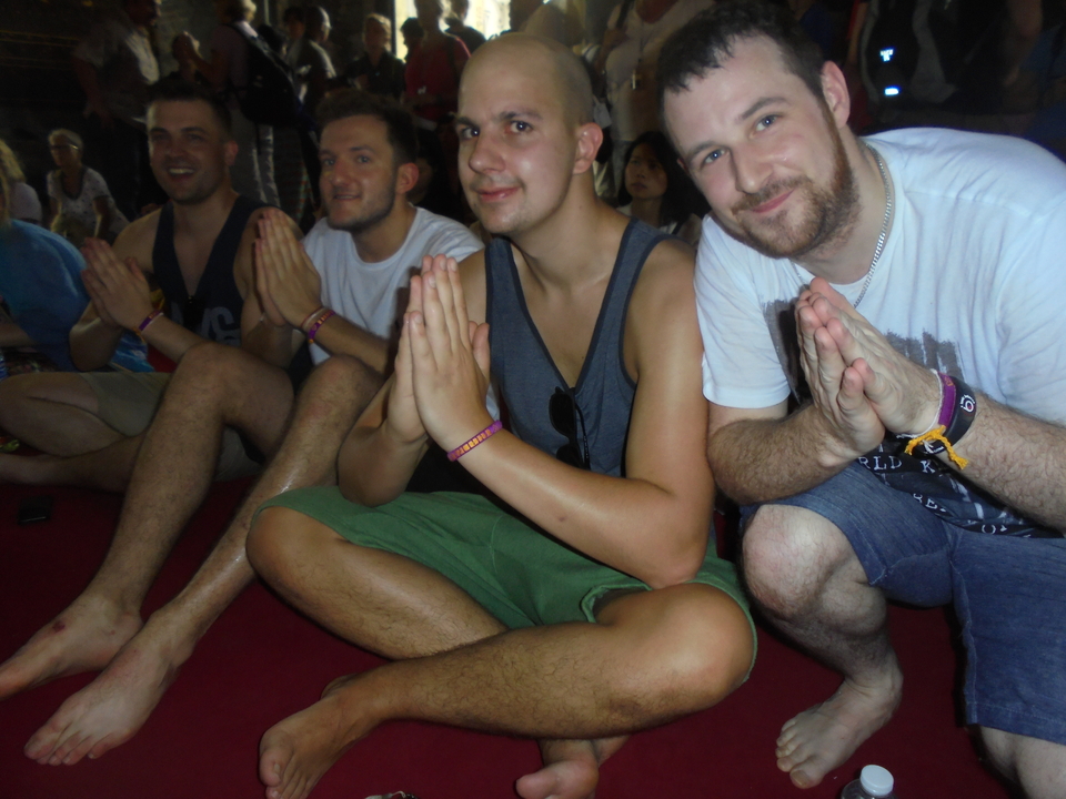 People sitting and posing with hands in front