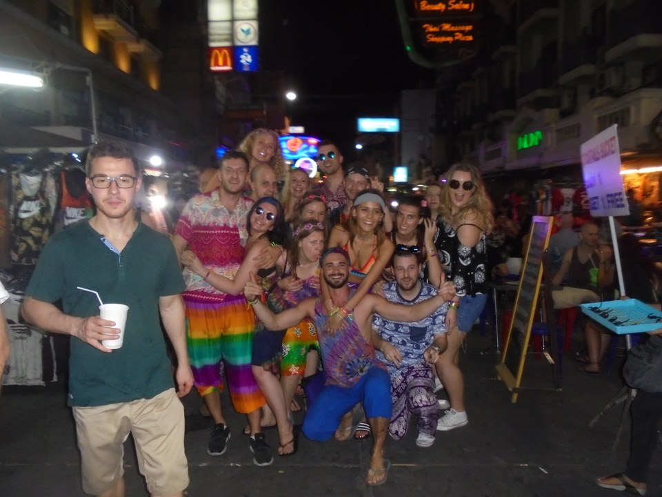 Group of people posing on a busy street.