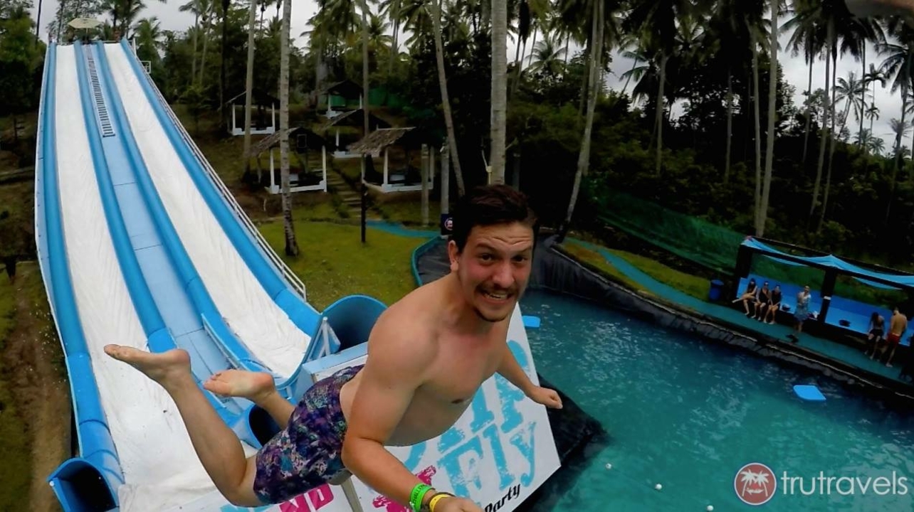 Person on a waterslide into a pool.