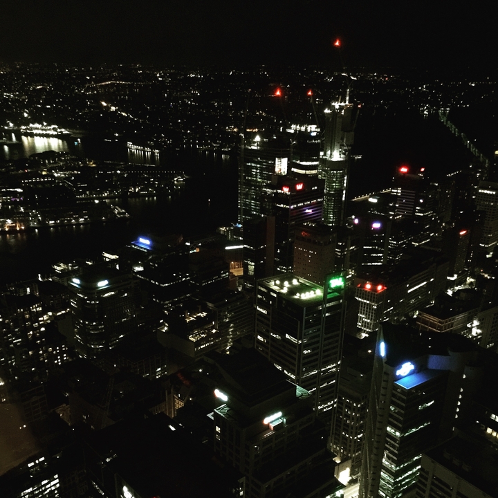City skyline at night with illuminated buildings.