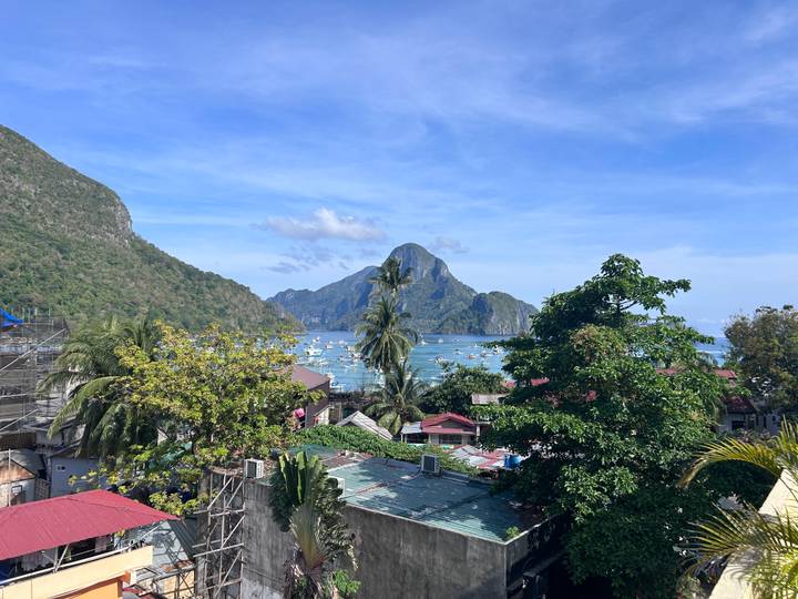 Tropical bay with lush mountains and boats.