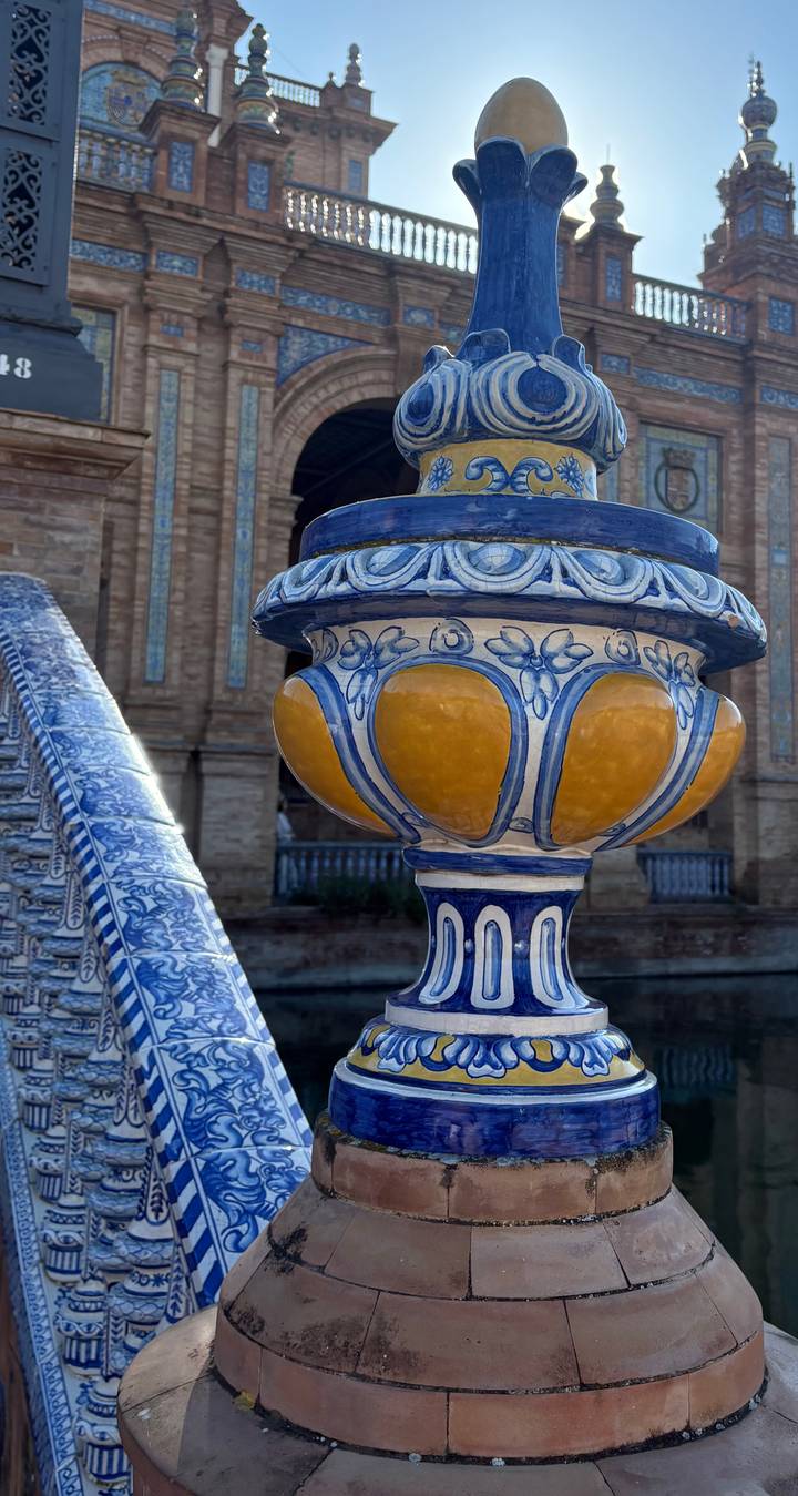 Close-up of a decorative ceramic structure with a background of building.