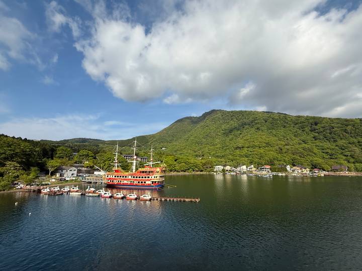 Scenic view of a lake with a dock and houses.