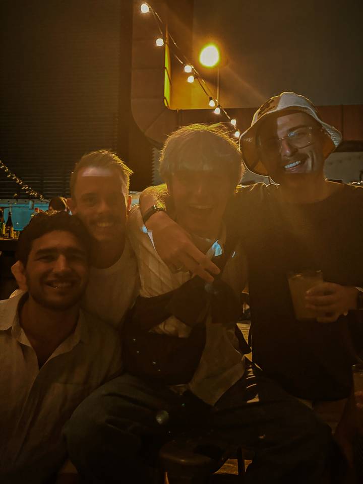 A group of friends photographed in dim lighting.