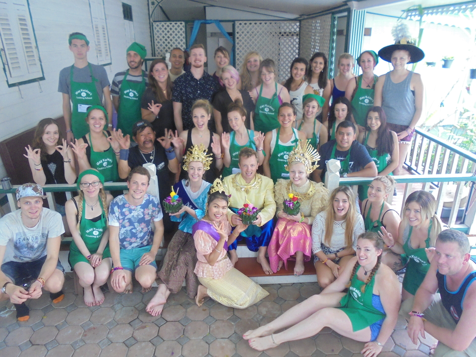 People posing with bright outfits and cultural attire.