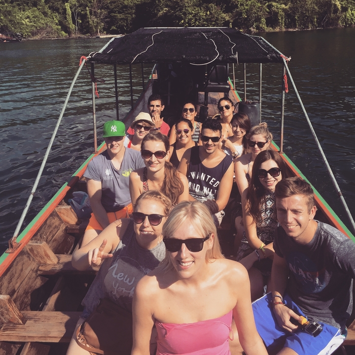Group of people on a boat posing for a photo.