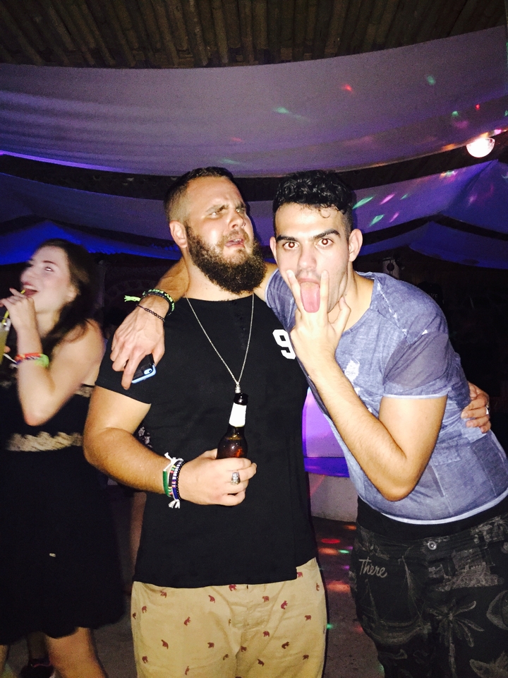 Two men posing at a party.