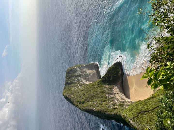 Dramatic cliffside landscape with sandy beach below.
