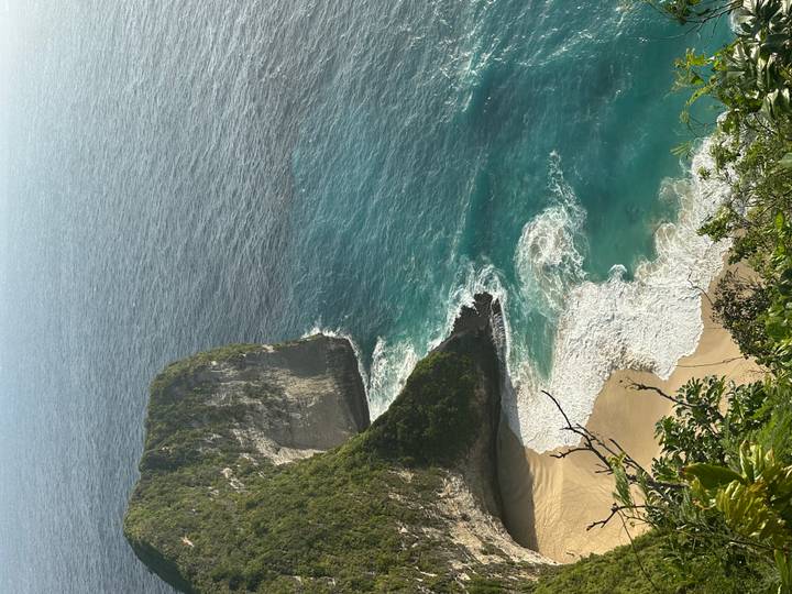 Coastal cliff with waves crashing at the base.