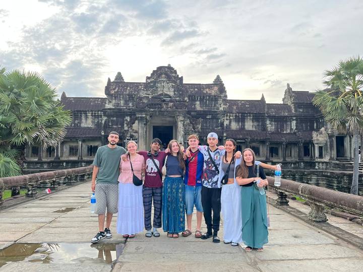 Group of people standing in front of Angkor Wat.