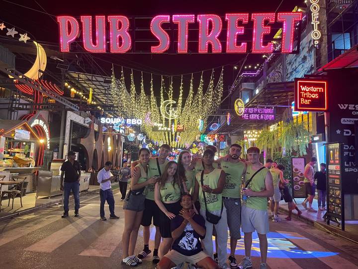 Group of people in Pub Street at night.