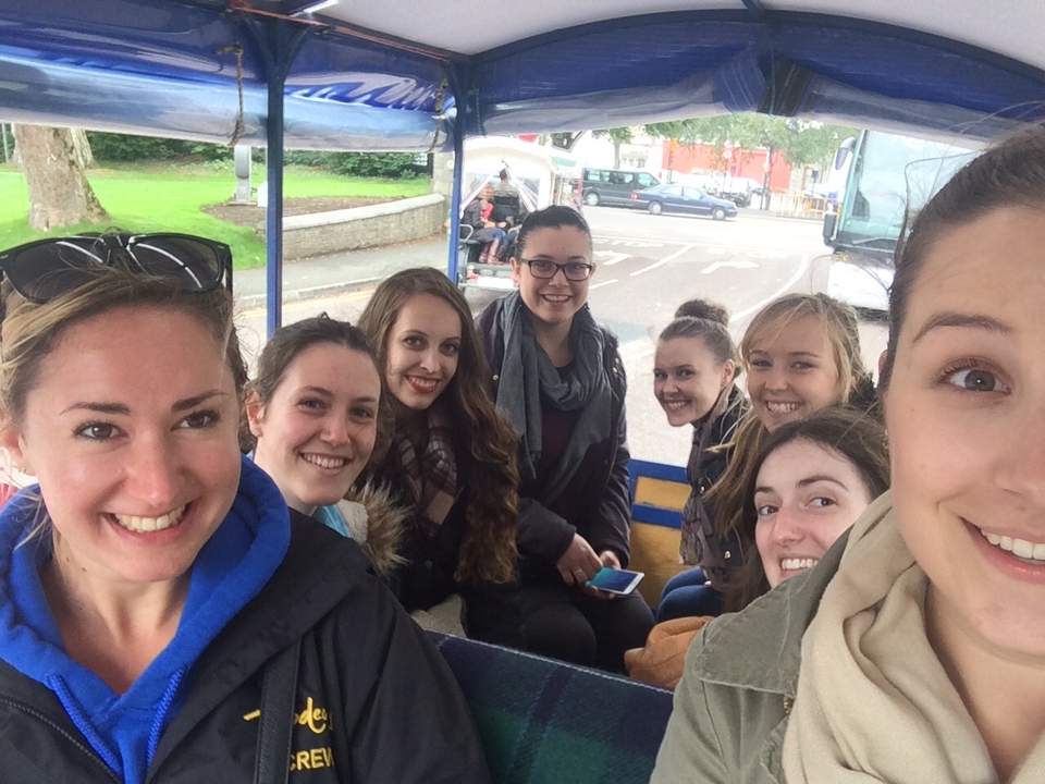 A group of friends inside a vehicle taking a selfie.