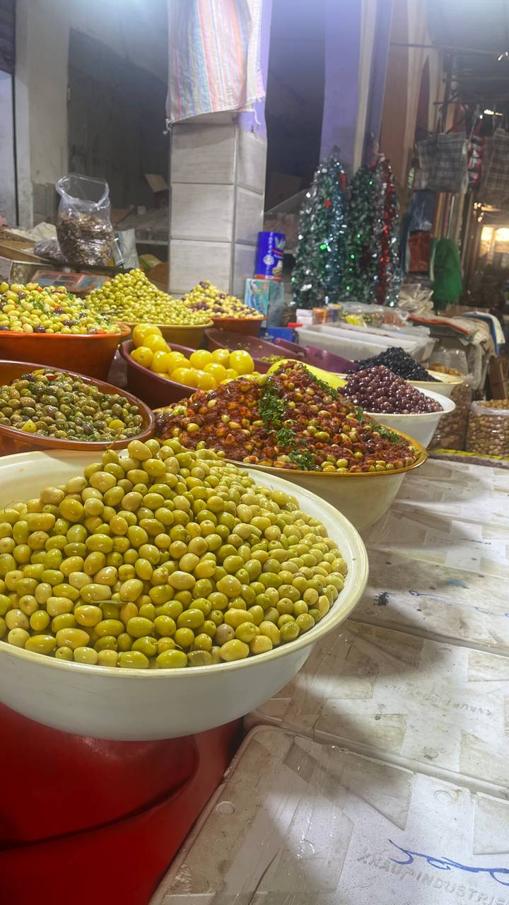 Variety of olives and preserved foods displayed at a market.