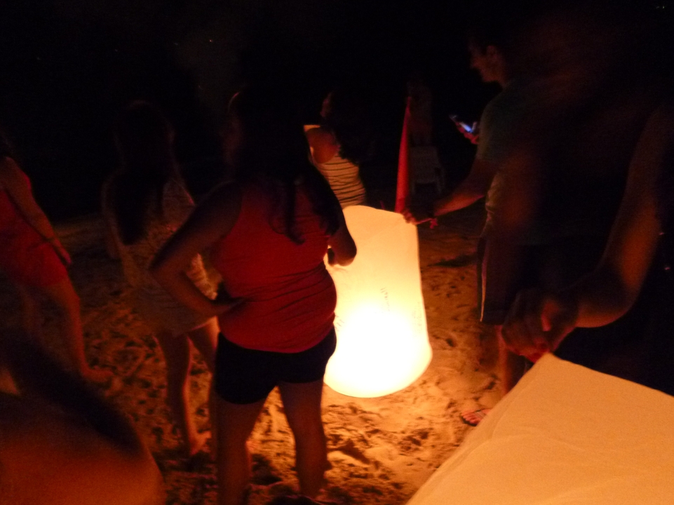 People launching lanterns at night.