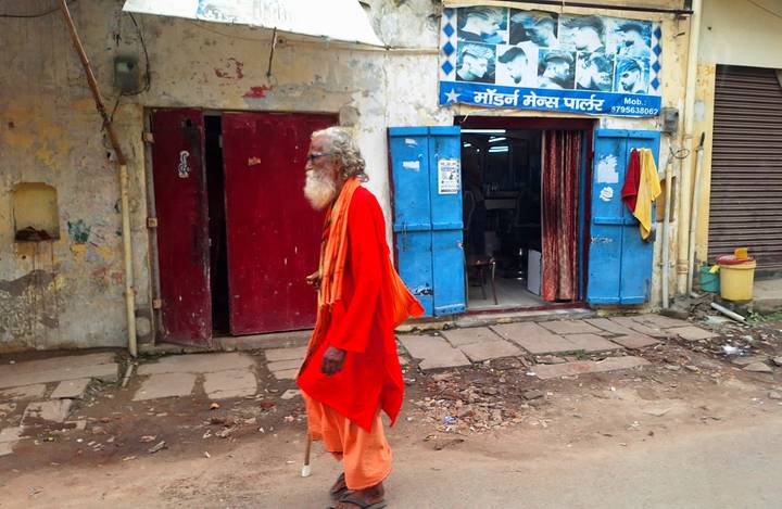 Man walking down a street in traditional attire.