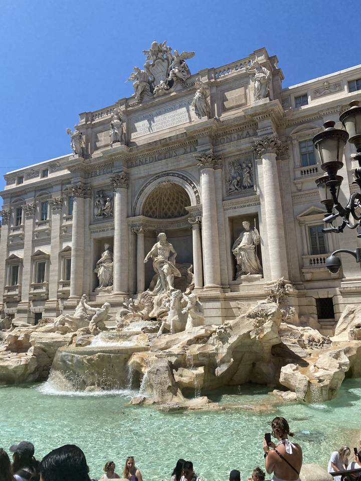 The Trevi Fountain with tourists around.