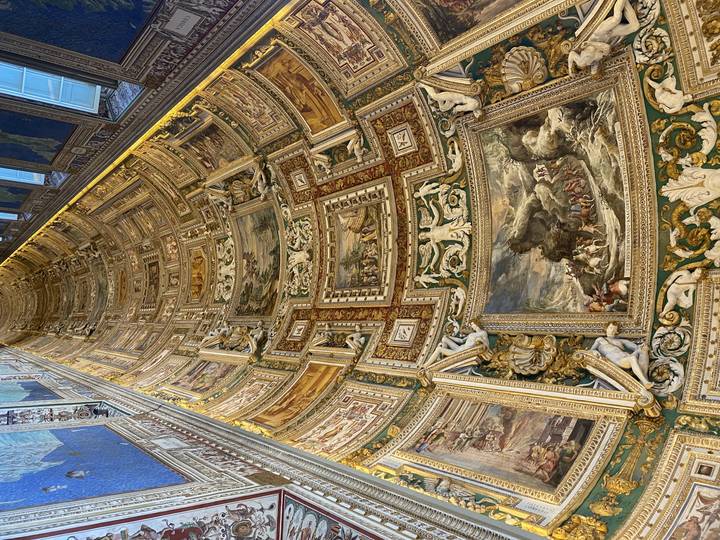 Ornate ceiling art in a gallery.