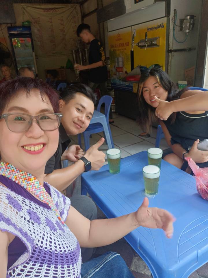 A group of people holding drinks together.