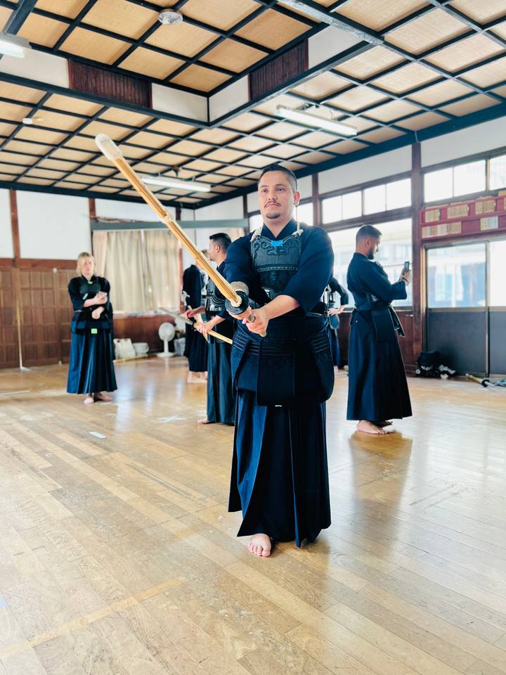 People practicing kendo in a martial arts setting.