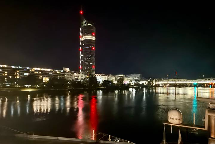 City skyline at night with lights reflecting on water
