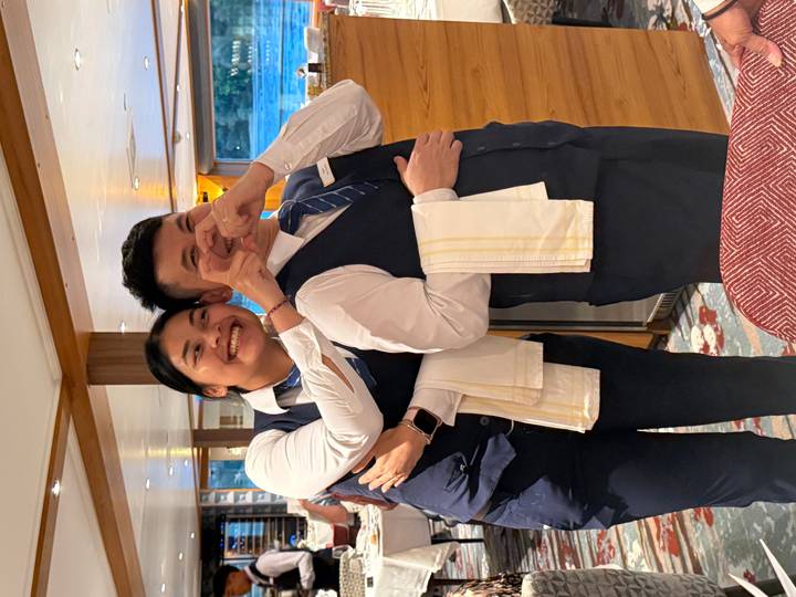 Two people in formal attire, one holding a microphone