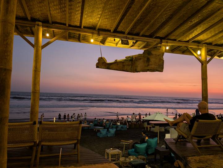 Beach sunset view from a wooden bar.