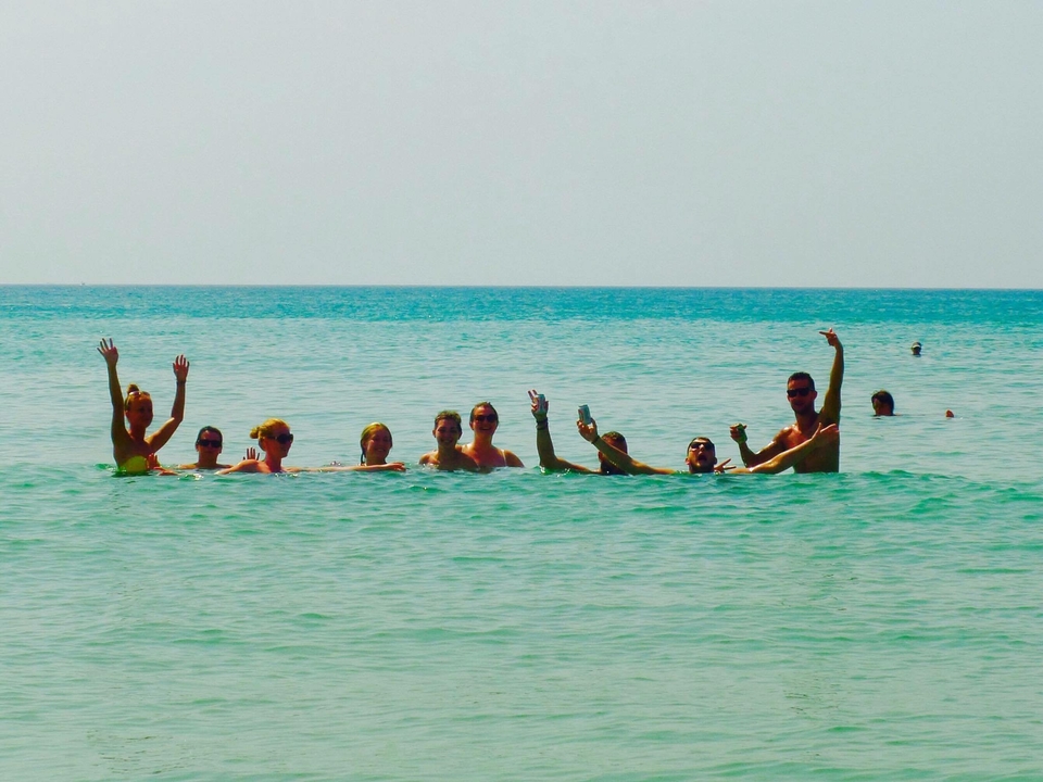 Group of people enjoying themselves in the ocean.