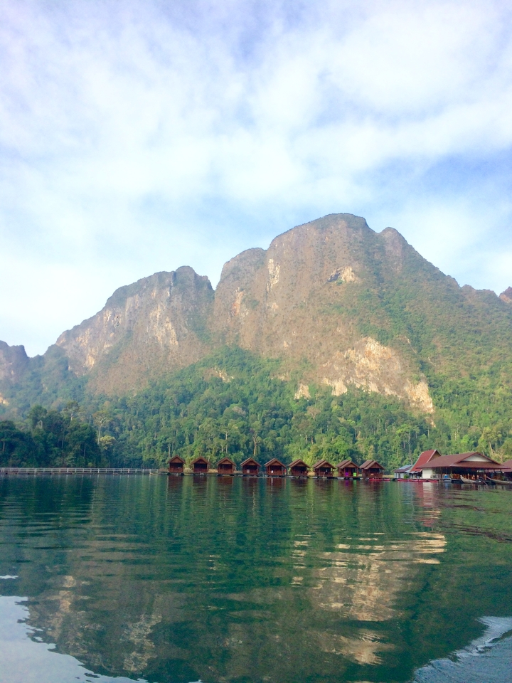 Scenic view of wooden cabins in front of a mountain.