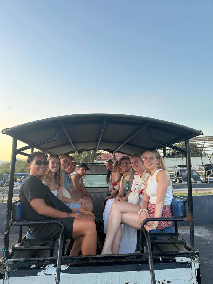 People sitting in an open-air vehicle during a tour.