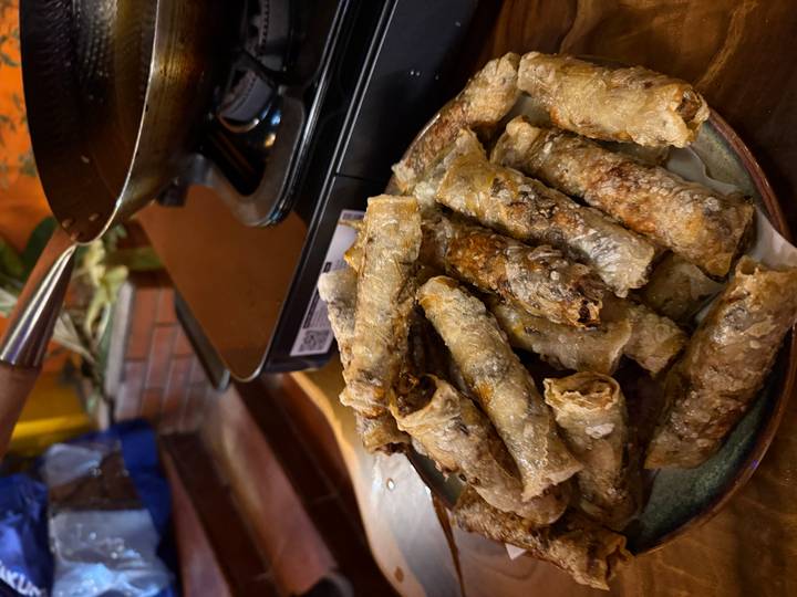 Plate of Vietnamese spring rolls next to a stovetop.