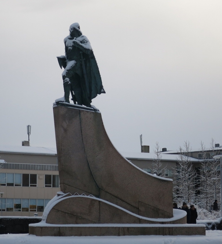 Statue in winter with snow-covered surroundings.