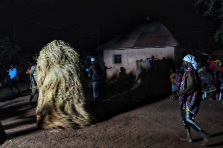 Traditional dance with people in costumes at night.
