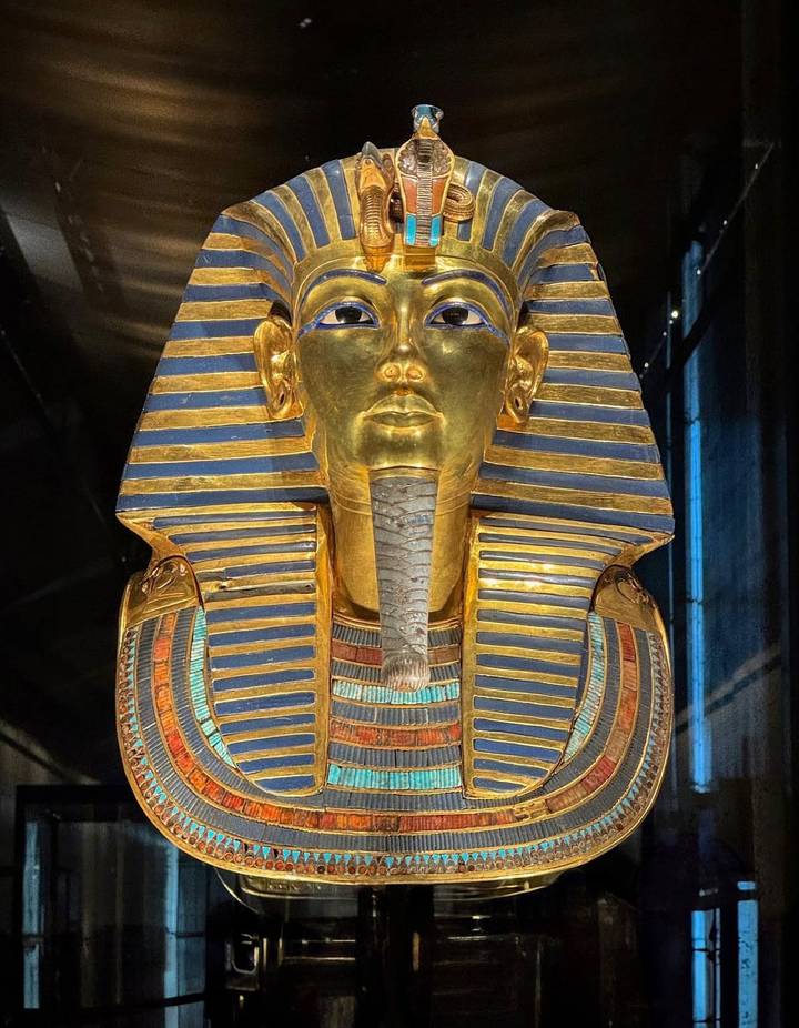 Golden mask of Tutankhamun displayed in a museum.