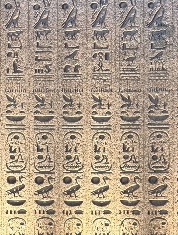 Wall adorned with ancient Egyptian hieroglyphs.