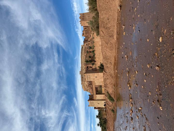 Ancient mudbrick fortress with a river in the foreground.