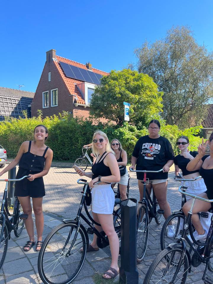 Group of friends on bicycles in a residential area.