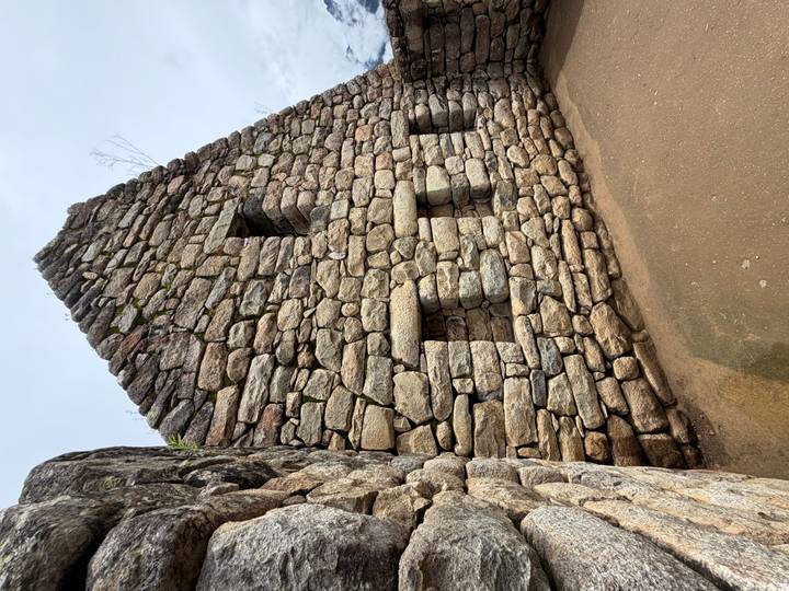 Stenen muur met nissen op een archeologische site.