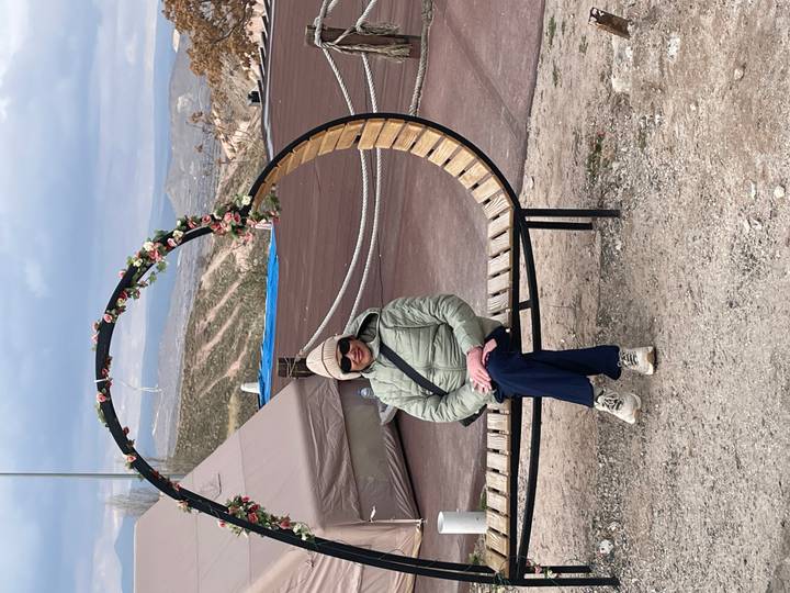 Underground cave lit by artificial light, with rough stone surfaces.