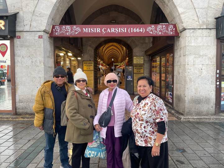 Group of people standing in front of the Misir Carsisi (Spice Bazaar) in Istanbul, Turkey.