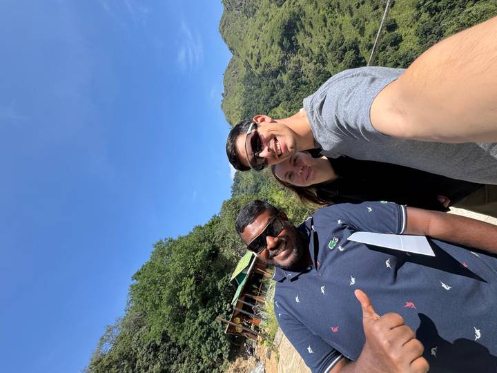 Three people taking a selfie in a mountainous area.