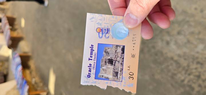 Person holding a ticket for the Oracle Temple.