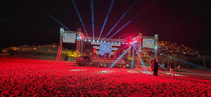 Concert stage set up in the desert at night.