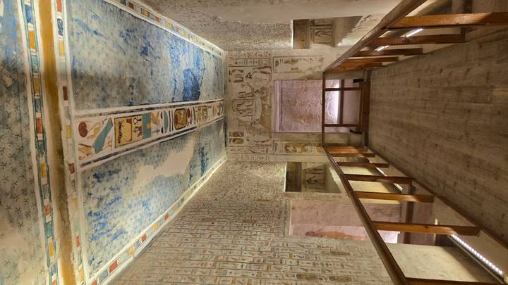 Interior of a tomb with detailed ceiling and wall art.