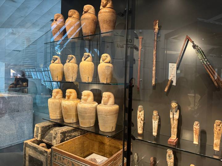 Ancient artifacts and canopic jars displayed in a museum.