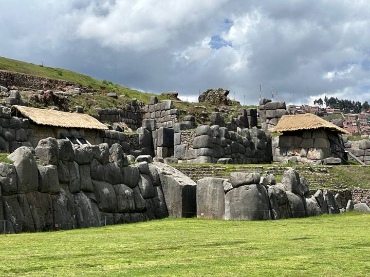 Ancient stone walls and thatched roof structures.