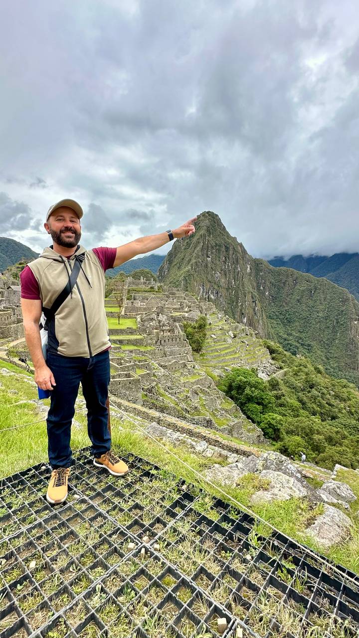 Man posing at Machu Picchu site.