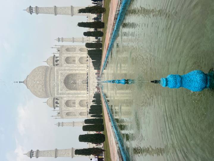 Taj Mahal with reflection in a water canal.