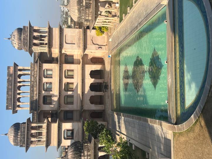 Palatial building with a swimming pool.