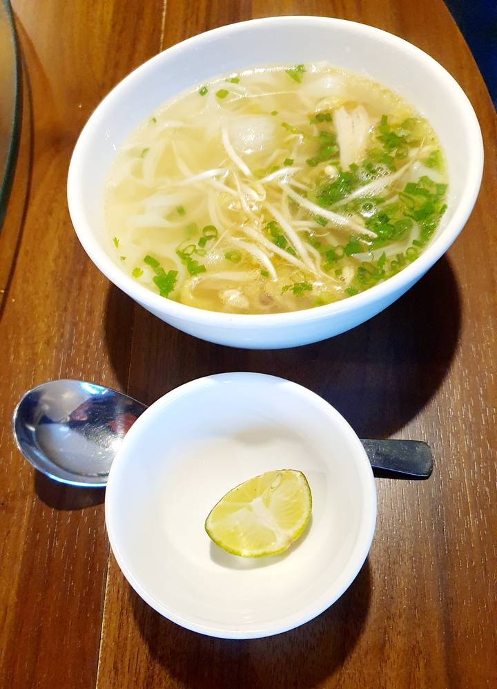 Tazones de sopa de fideos vietnamita en una mesa.