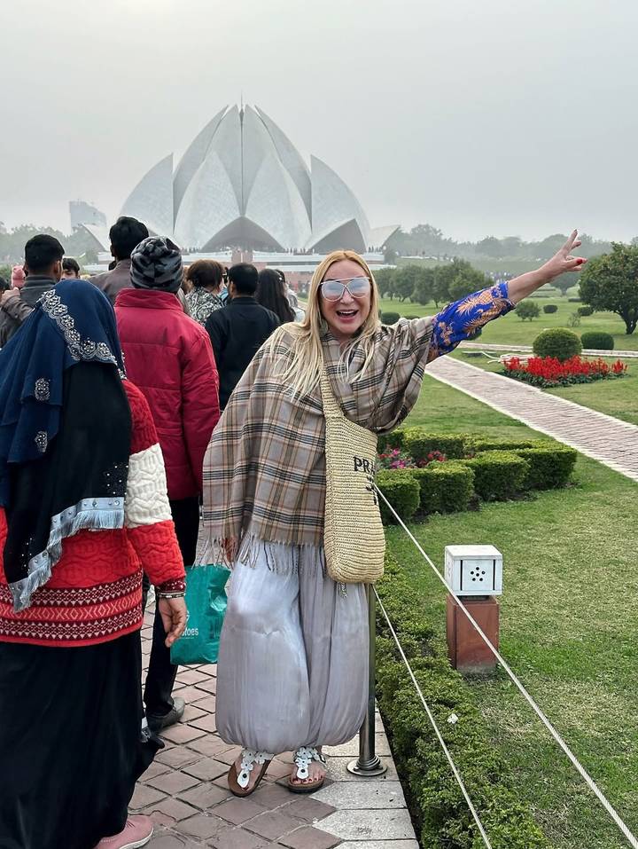 Mujer alegre con un grupo de personas en un jardín grande.